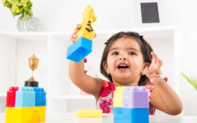 cute-little-indian-asian-girl-enjoying-while-playing-with-toys-blocks-sitting-table-1-scaled (1)